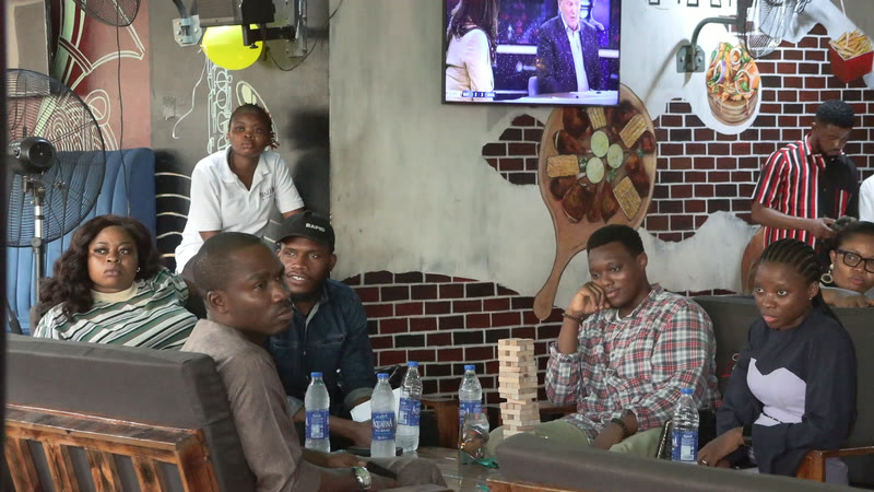Members relaxing and chatting around tables