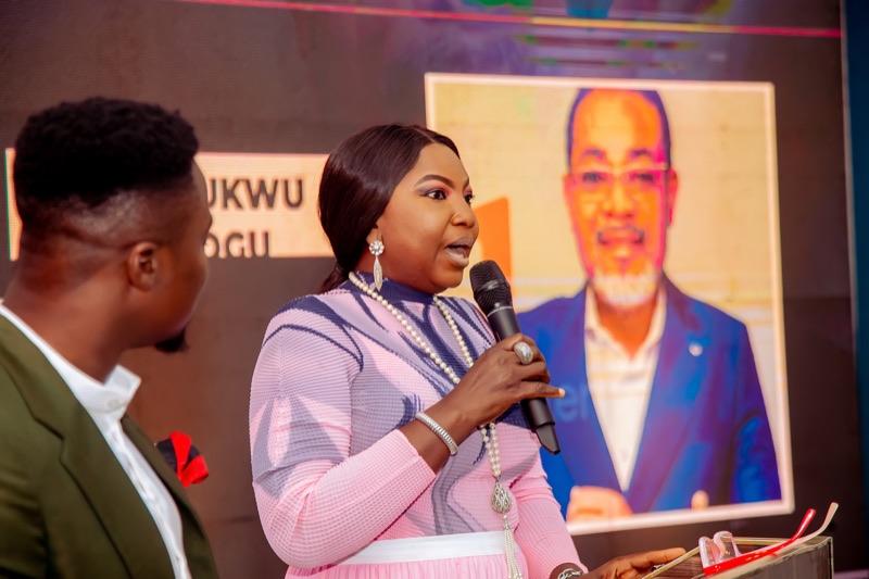 An attendee speaking into a microphone beside the host
