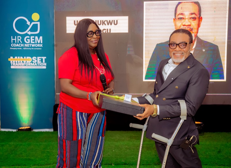 A guest speaker receiving a gift on stage