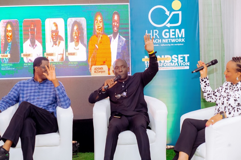 A panellist raising his hand as the panel discusses