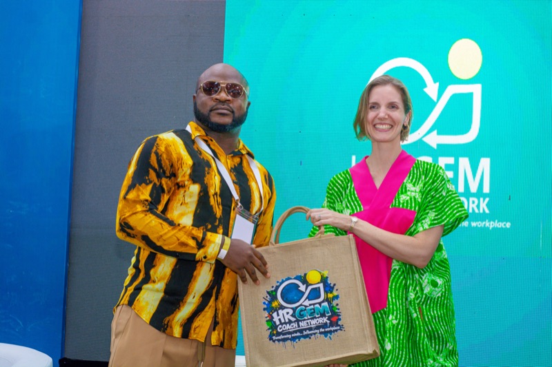 A guest receiving an HR GEMs gift bag on stage